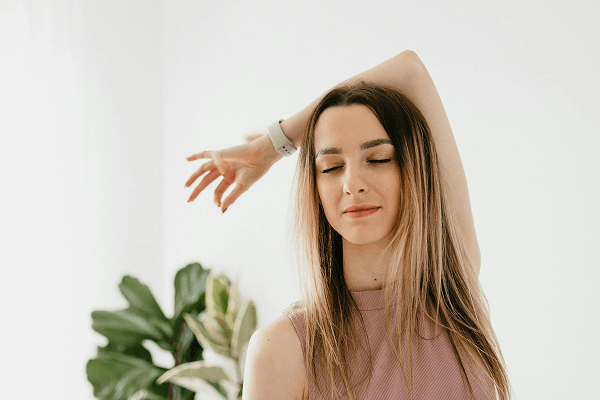 Woman radiating a relaxing aura in a calm, peaceful environment.
